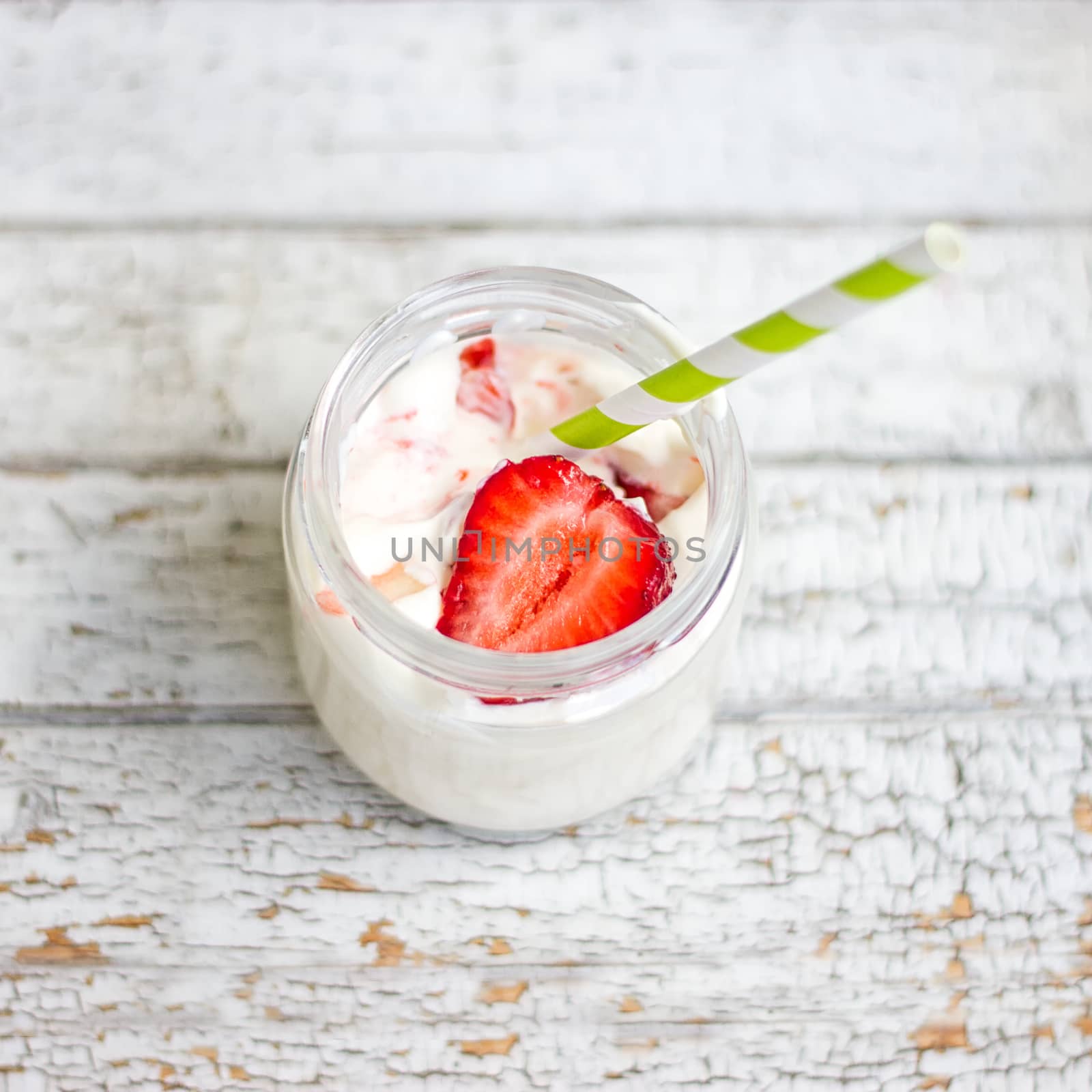 Smoothie yogurt, strawberries in glass jar on wooden by victosha