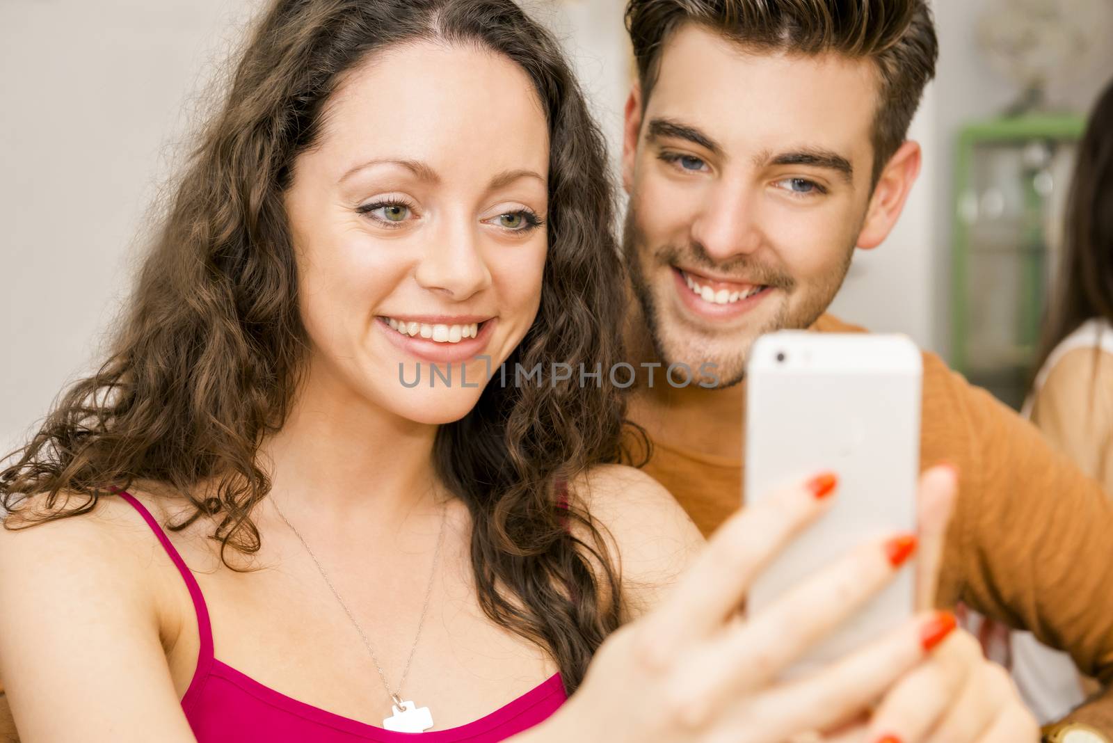 Happy couple at the restaurant making a selfie