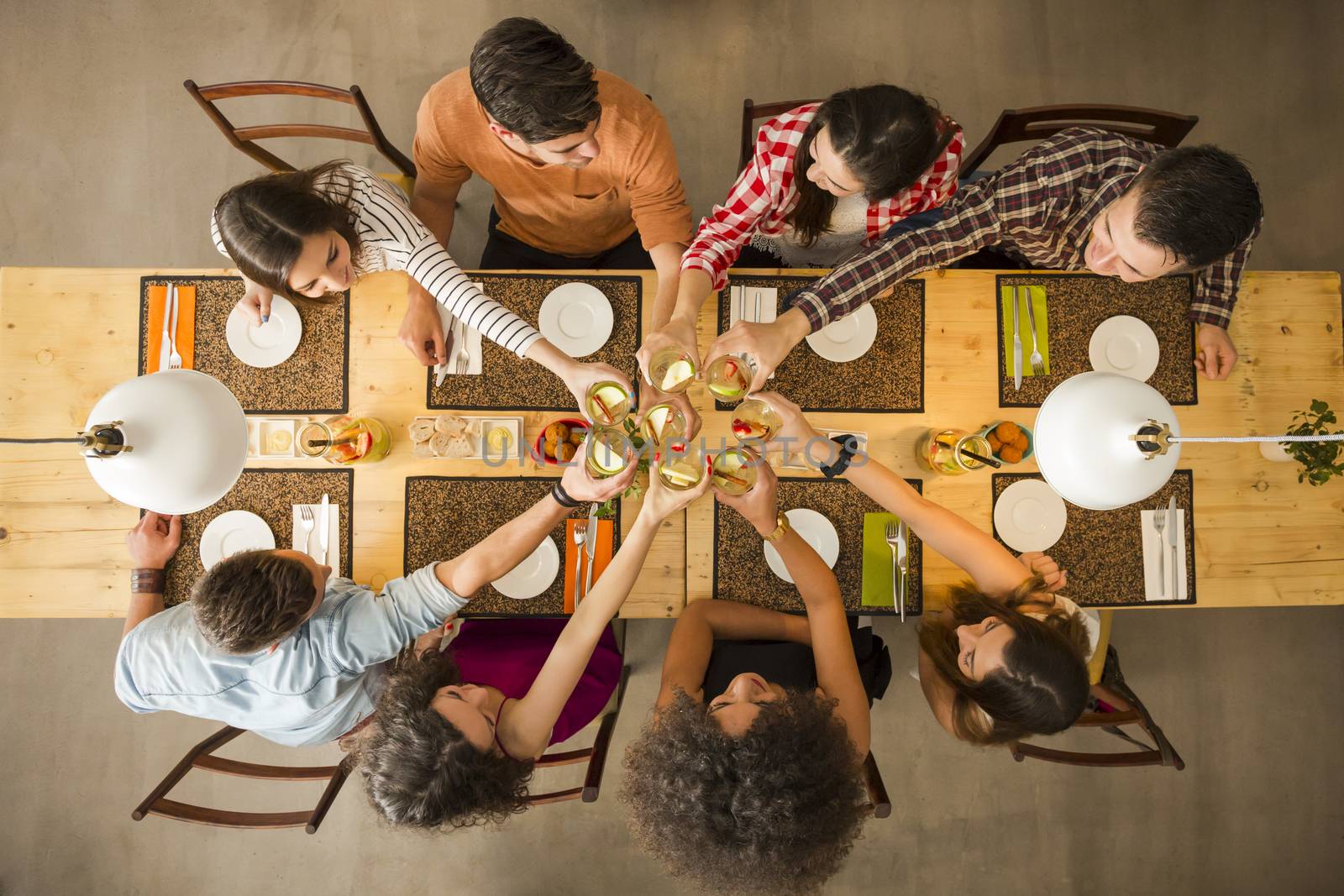 Group of people toasting and looking happy at a restaurant