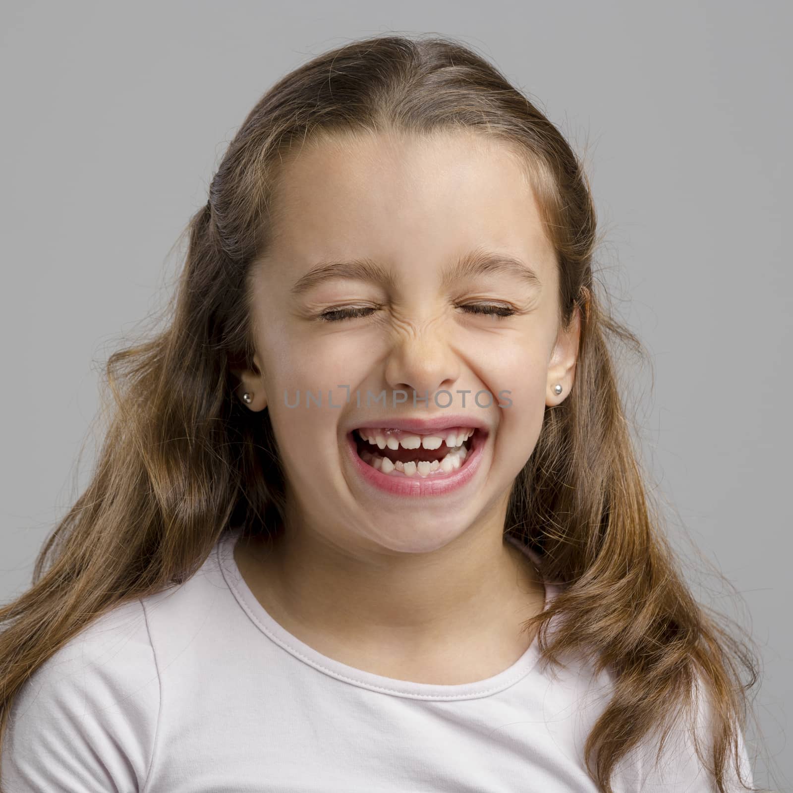 Portrait of a little girl with a laughing expression