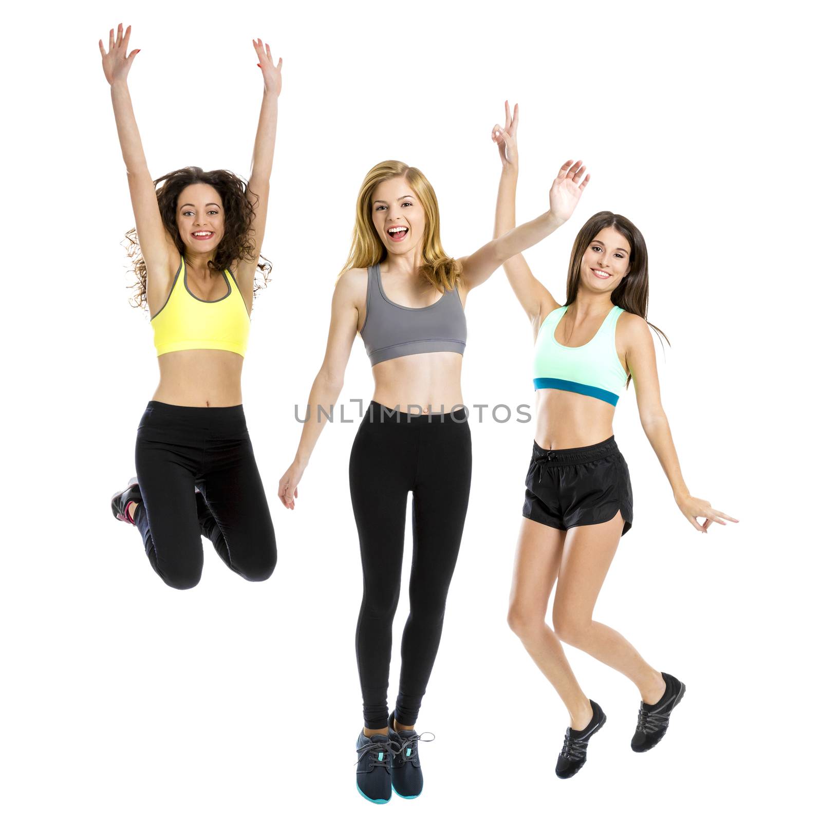 Portrait of three beautiful and athletic girls Jumping