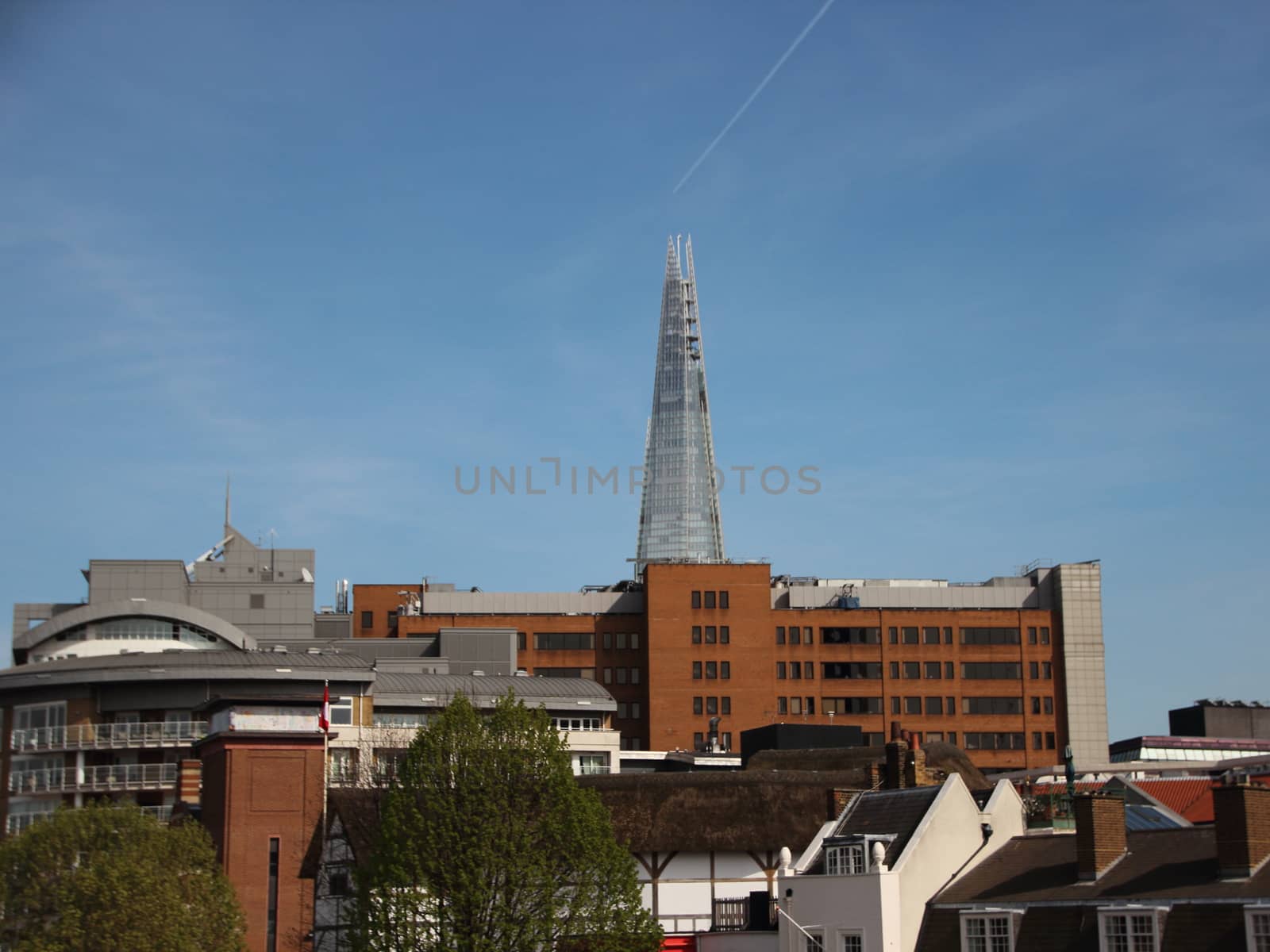 The Shard Tower in London England with Airplane