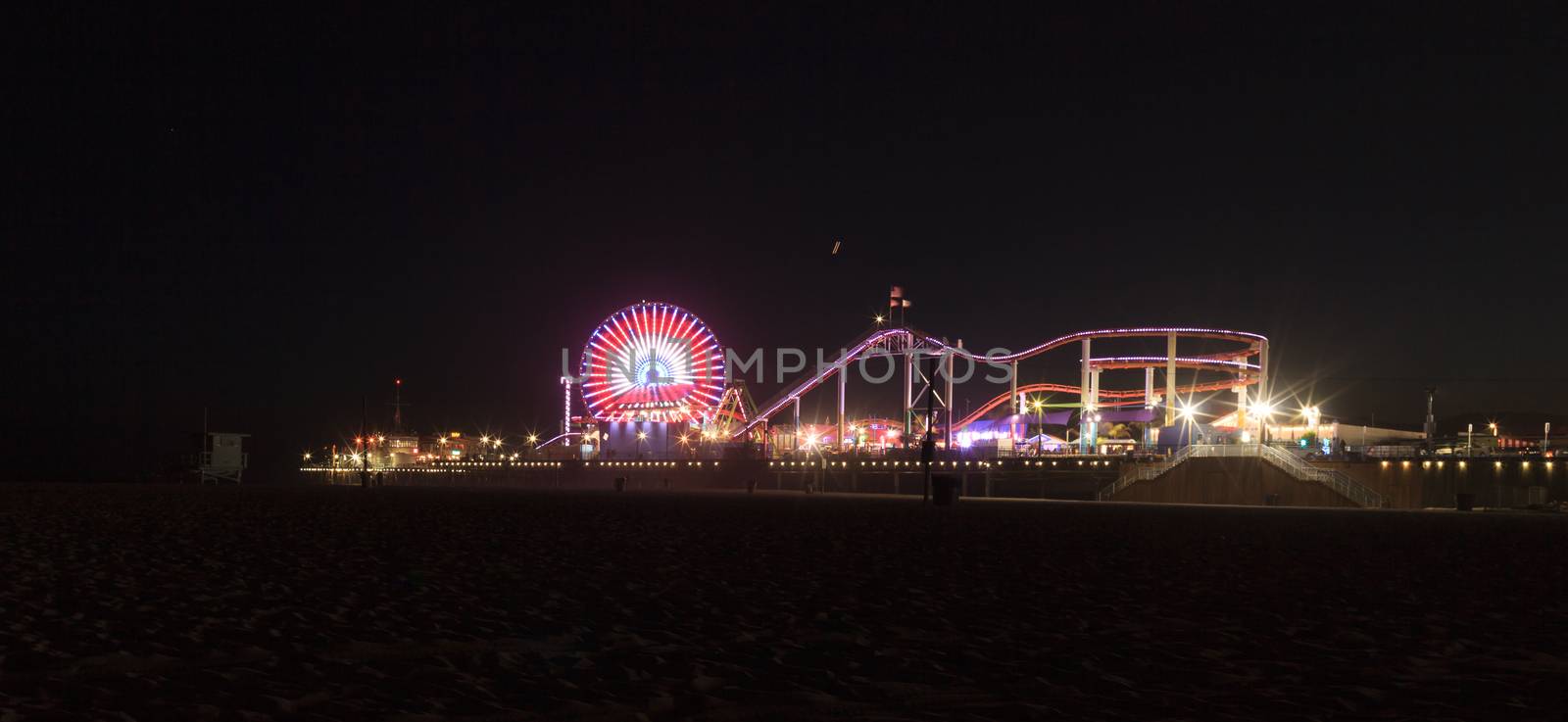 Santa Monica, California — April 24, 2016: Santa Monica Pier boardwalk lit up at night in Southern California. Editorial use.