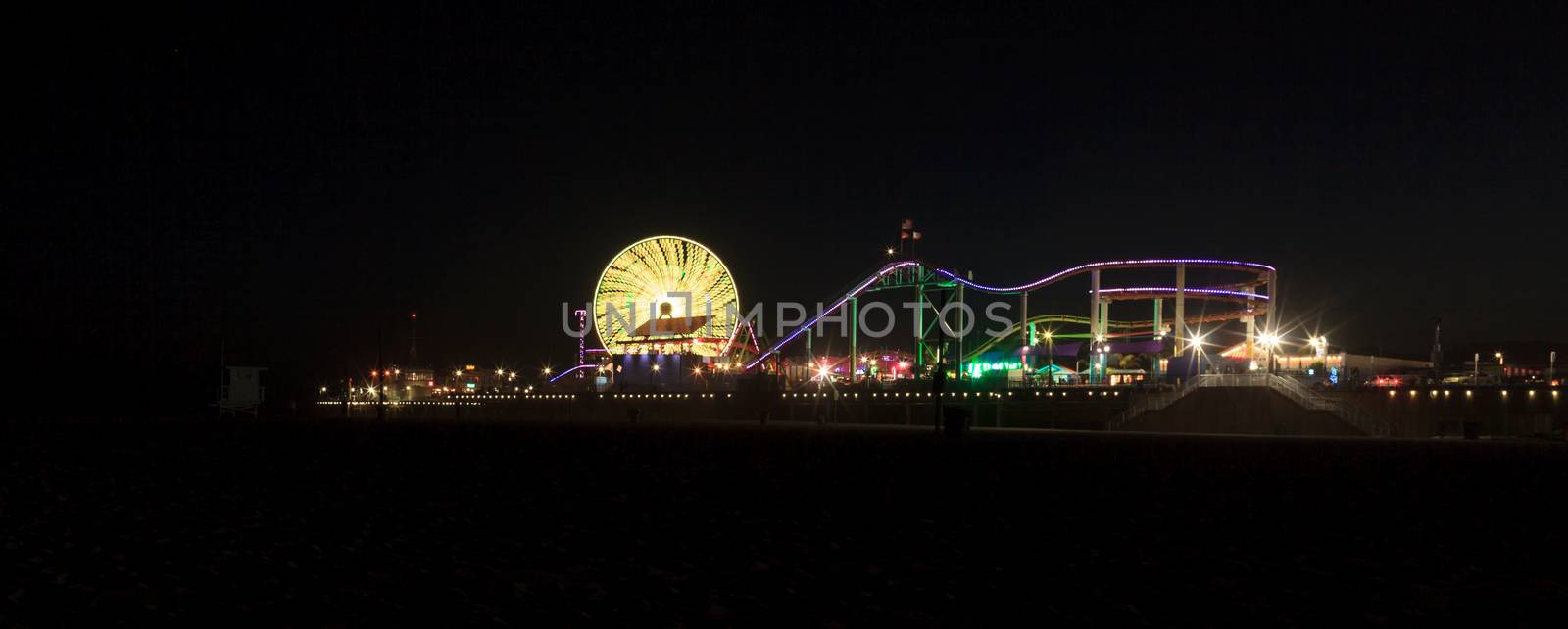 Santa Monica, California — April 24, 2016: Santa Monica Pier boardwalk lit up at night in Southern California. Editorial use.