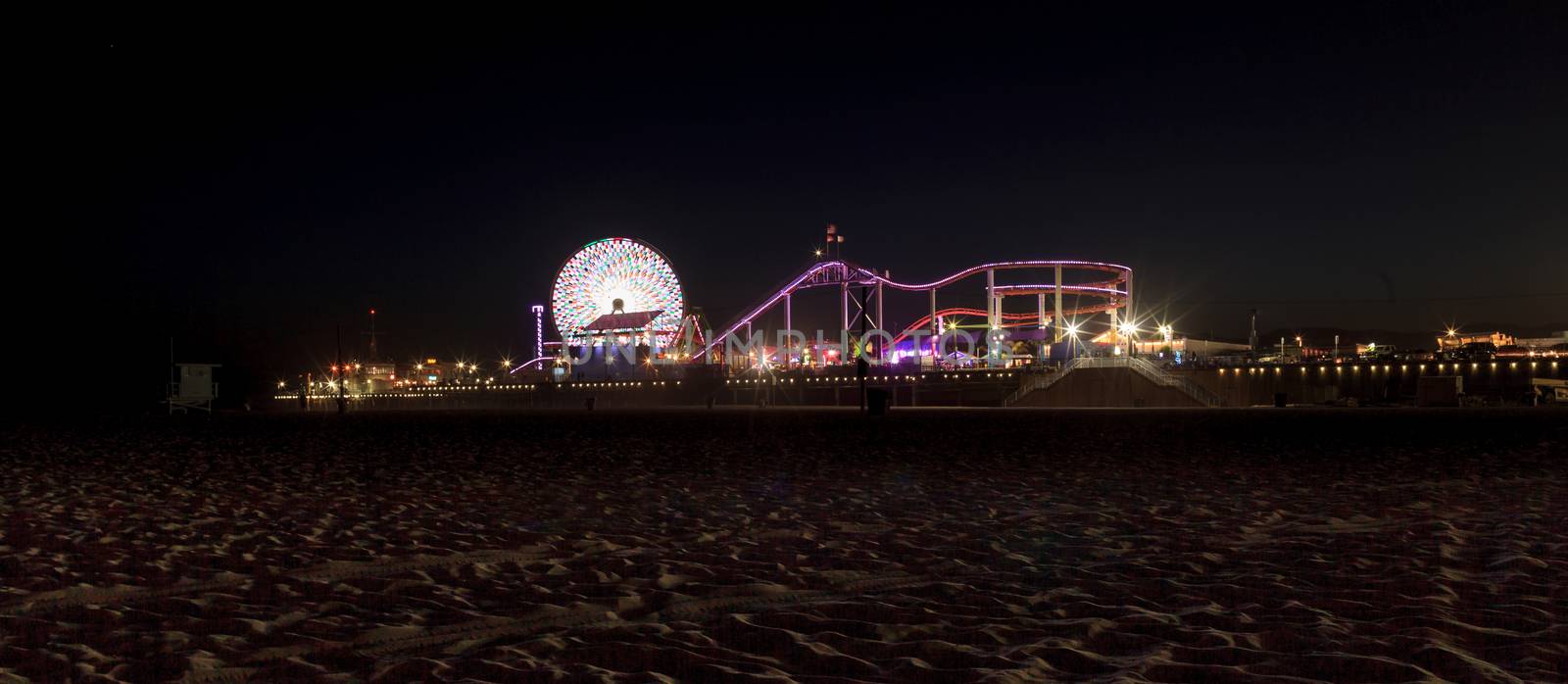 Santa Monica, California — April 24, 2016: Santa Monica Pier boardwalk lit up at night in Southern California. Editorial use.