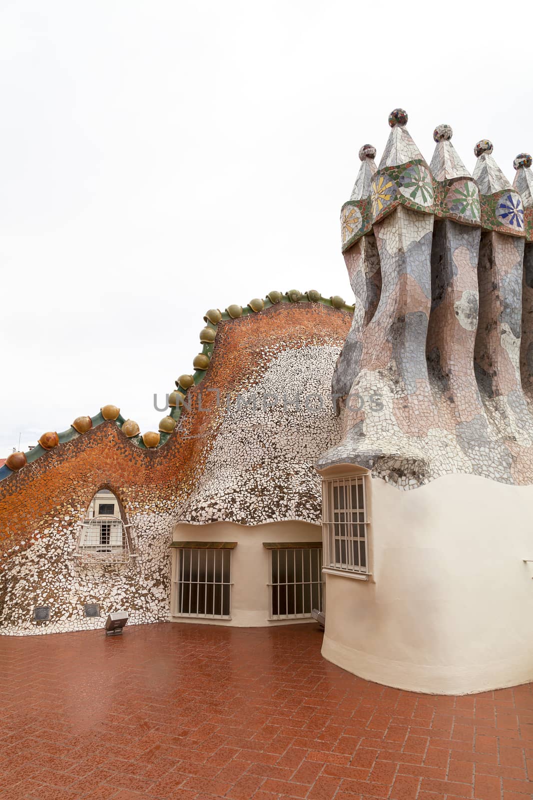 Barcelona, Spain - May 11,2016 : Casa Batllo,  housetop , chimneys with ceramic mosaic. Building  redesigned in 1904 by Gaudi located in the center of Barcelona, it  is on the UNESCO World Heritage Site.