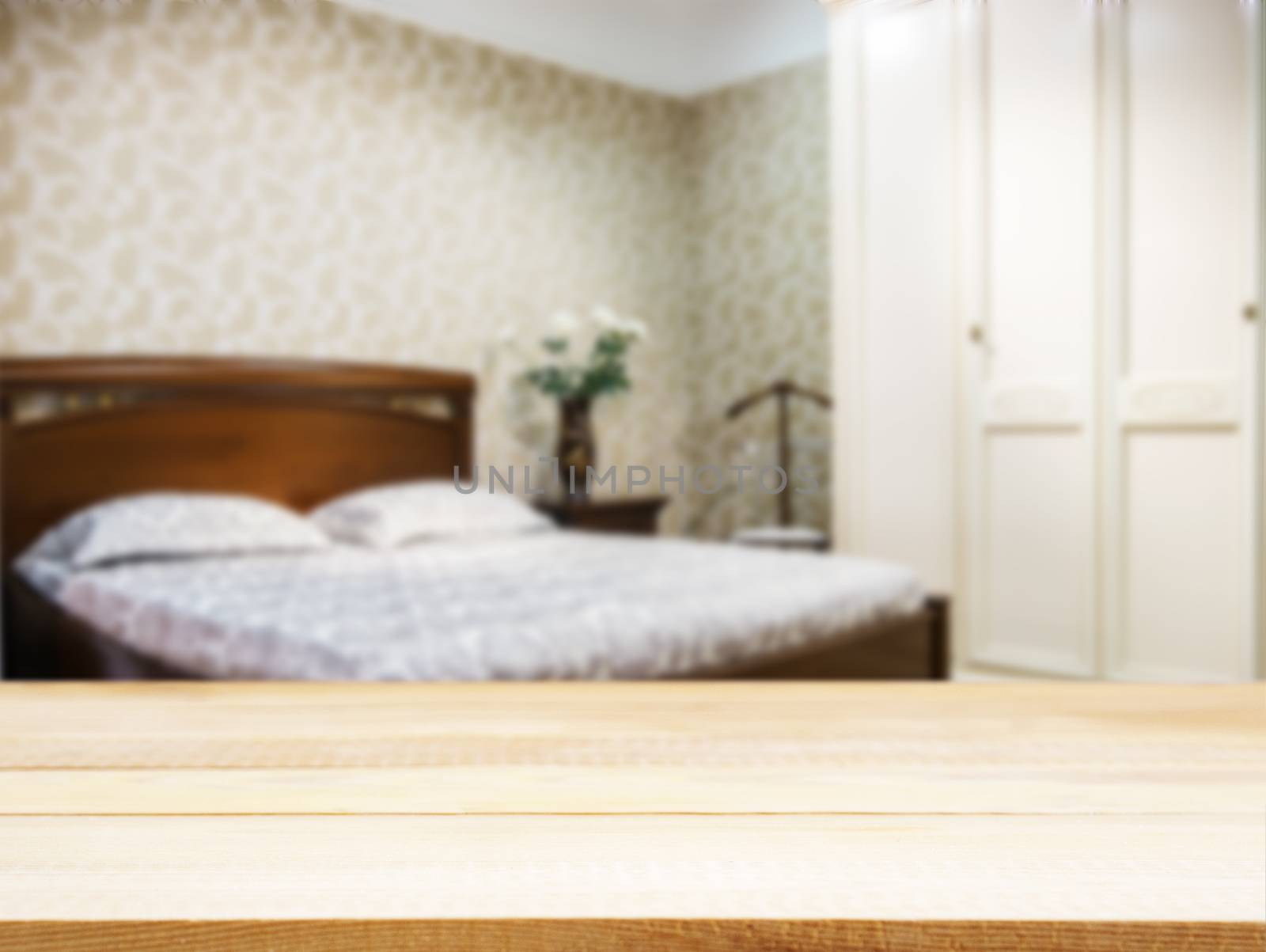Wooden board empty table in front of blurred background. Perspective light wood over blur in modern bedroom with brown wooden bed. Mock up for display or montage your products