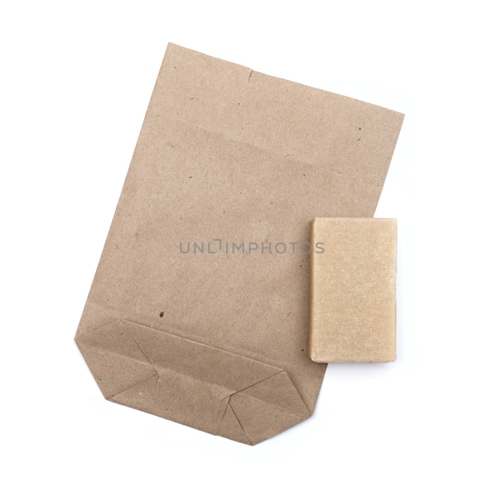 Brown paper bag isolated over white background by DNKSTUDIO