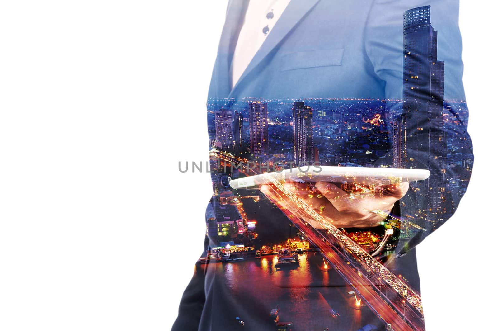 Double Exposure image of Businessman use Digital Tablet and City Building at Twilight as Business Technology concept