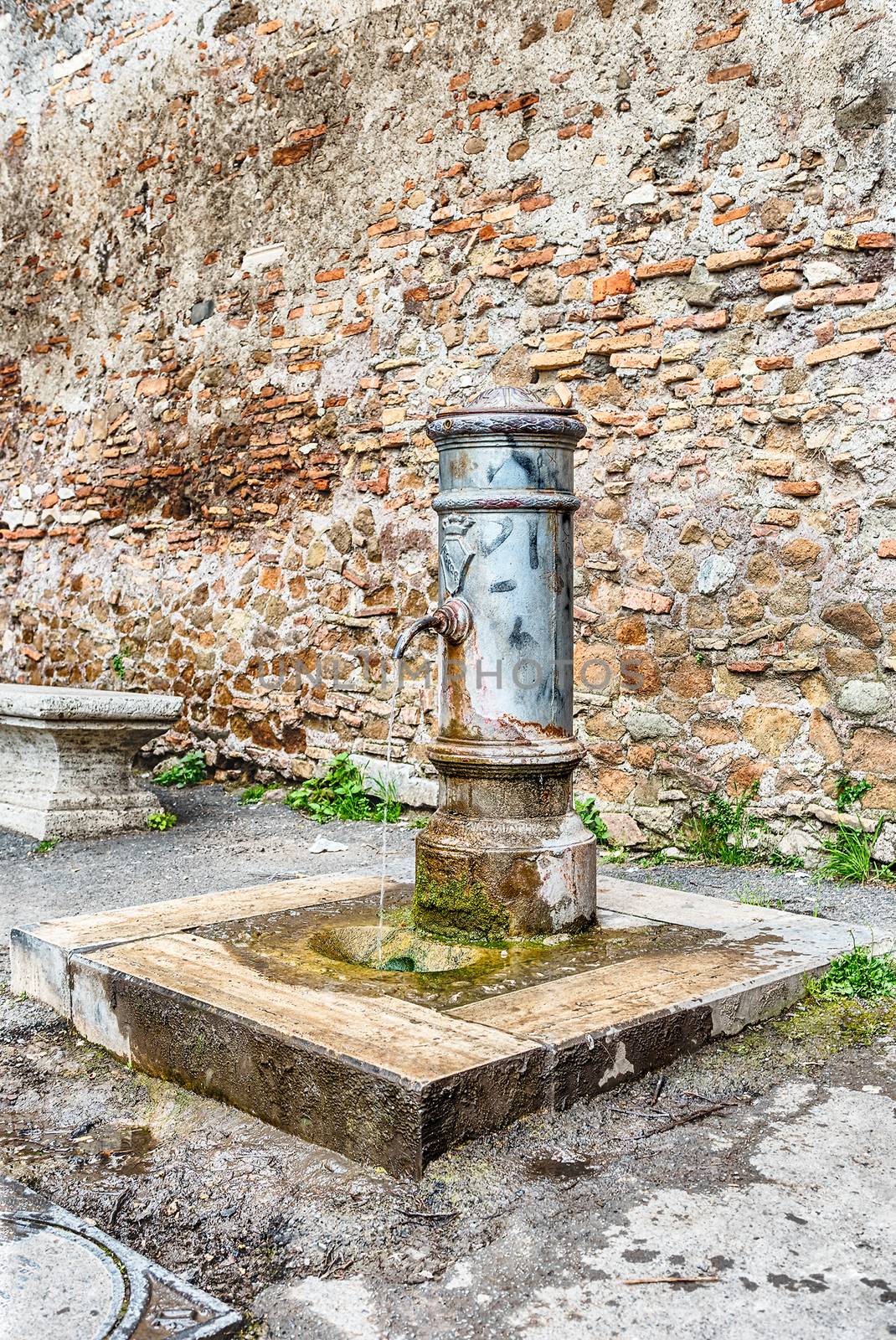 Traditional free water public fountain in Rome, Italy by marcorubino