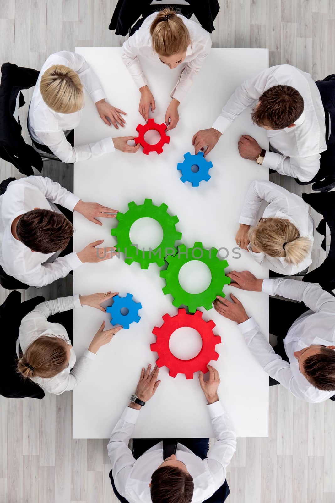 Teamwork with cogs of business by ALotOfPeople