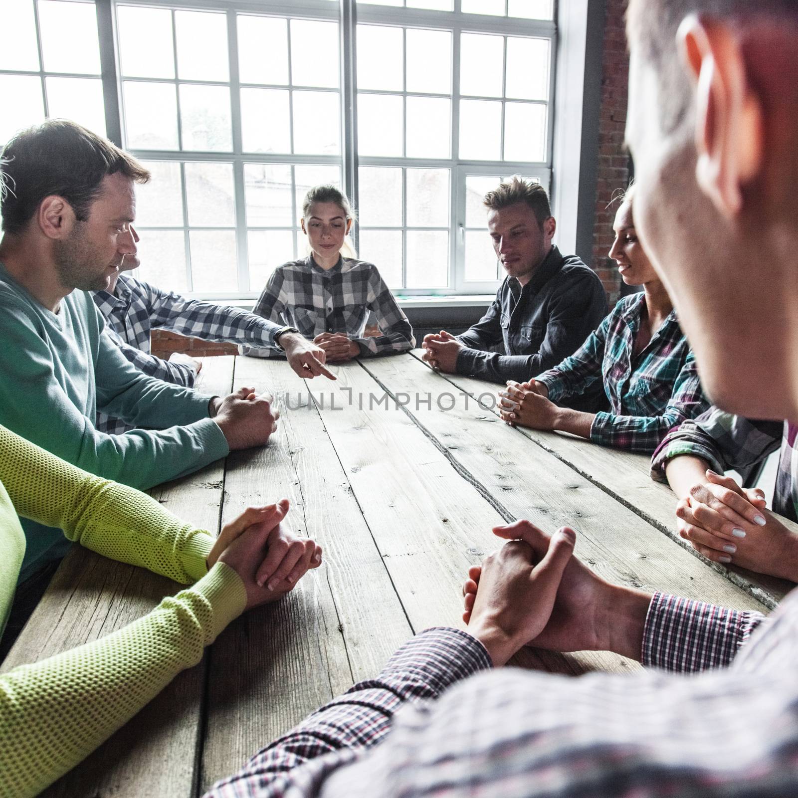 Modern business meeting concept, people on casual clothes sitting around wooden table