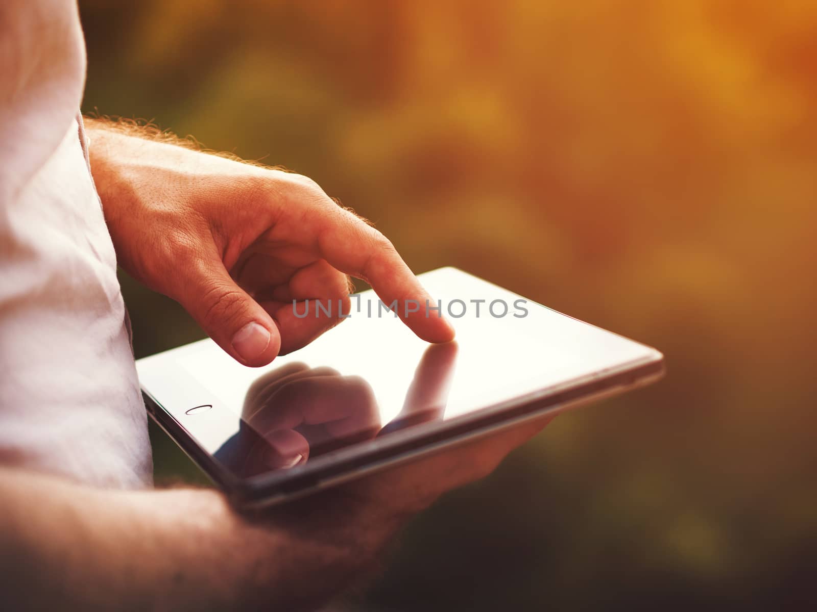 Man with digital tablet outdoors, close up by fascinadora