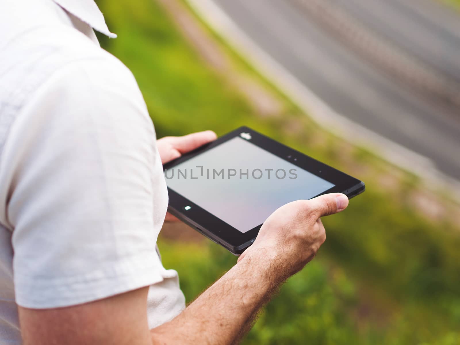Man with digital tablet outdoors, close up by fascinadora