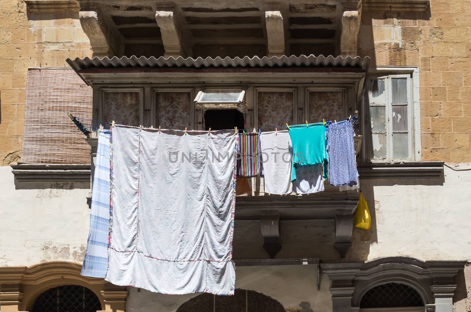 Traditional balcony with laundry, island Malta by YassminPhoto