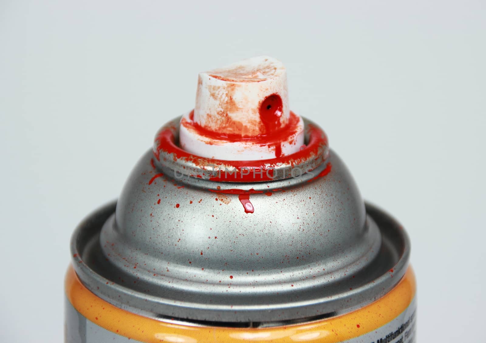Top of spray can with red paint