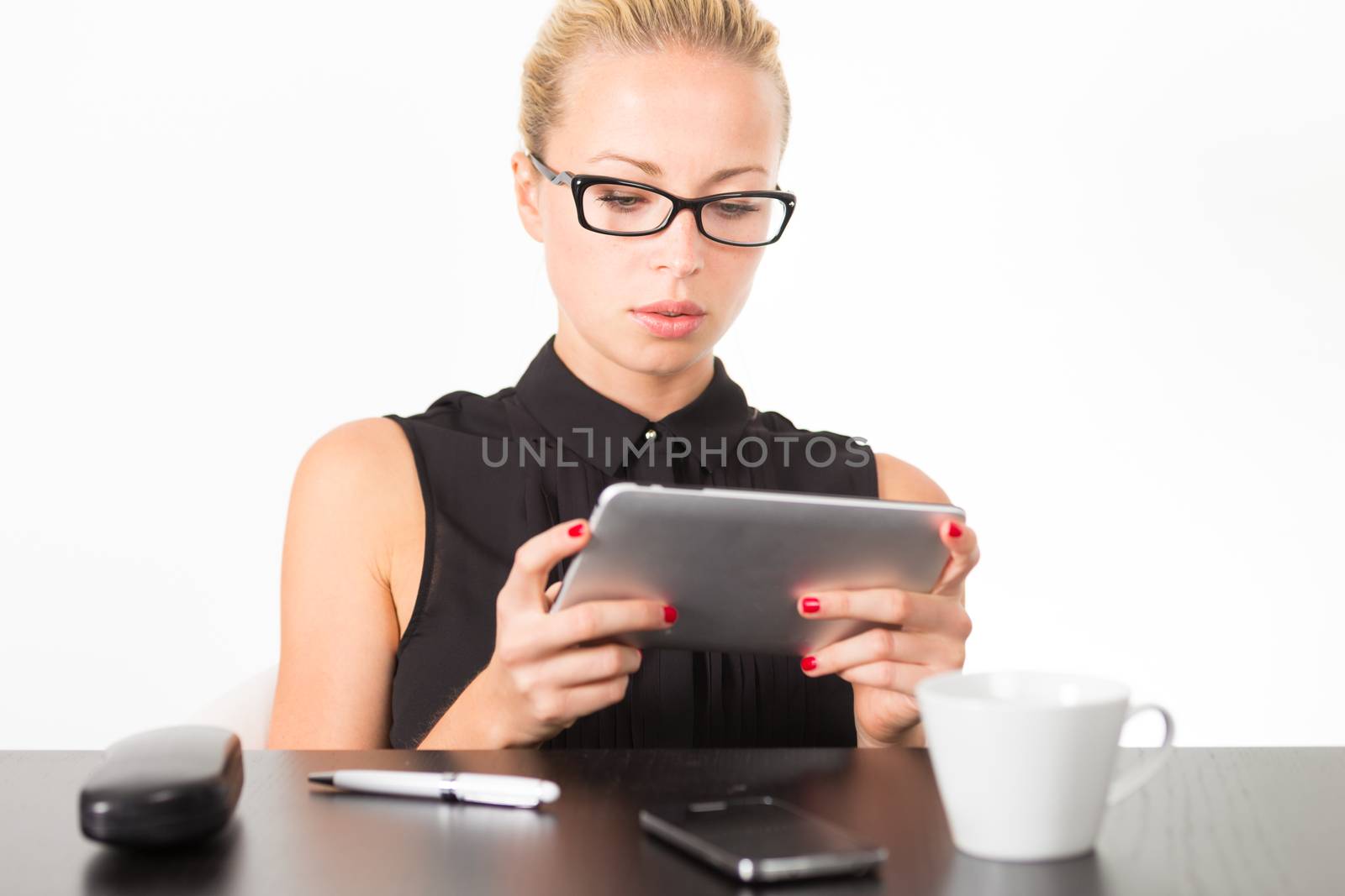 Business woman working on tablet PC. by kasto