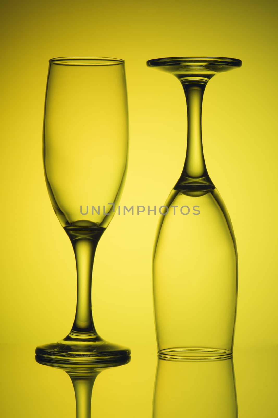 Two empty glasses in yellow light