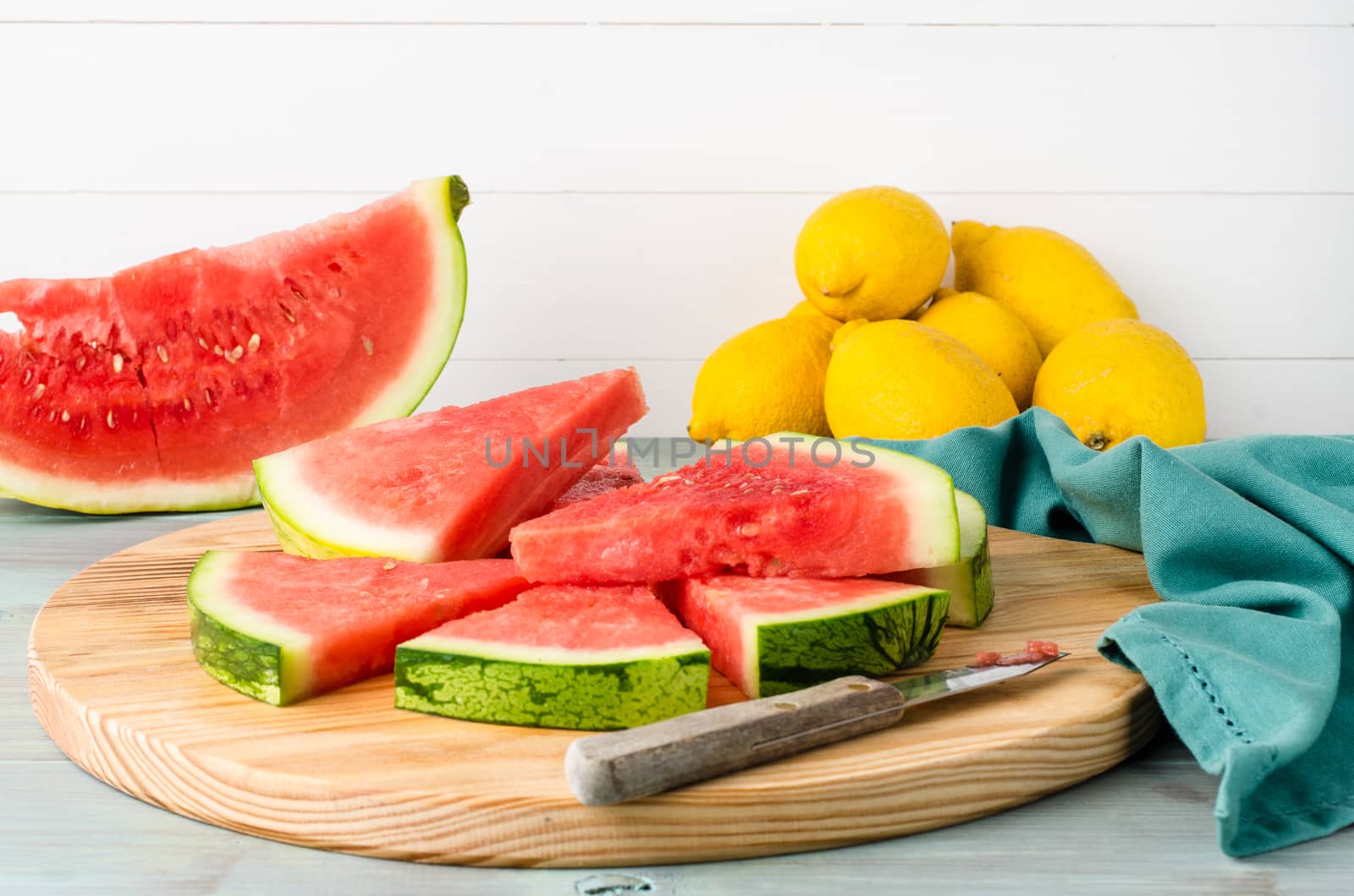 Slices of watermelon on a wood cutting board by AnaMarques