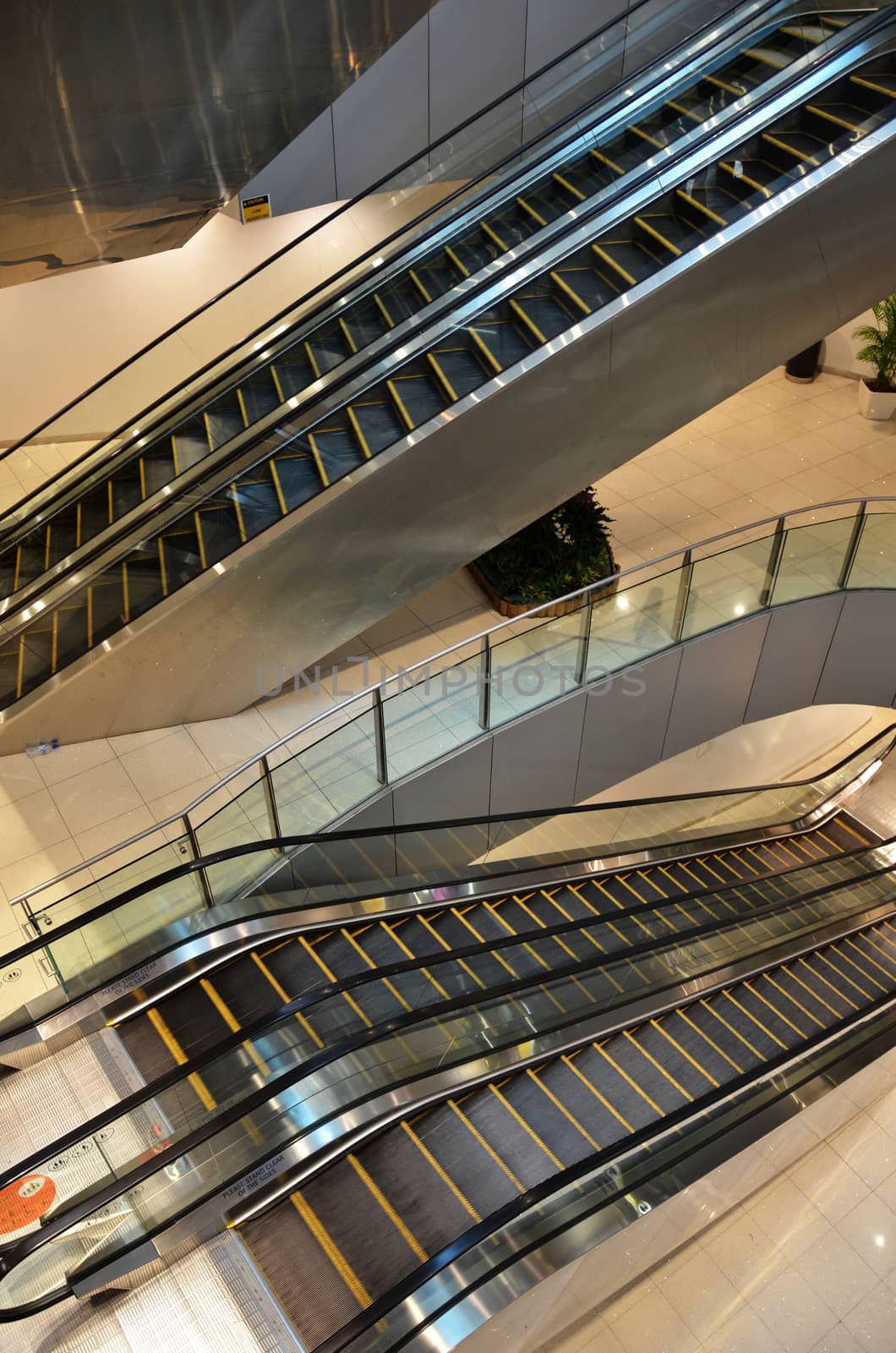 Looking down at multiple escalators in an office building or mall