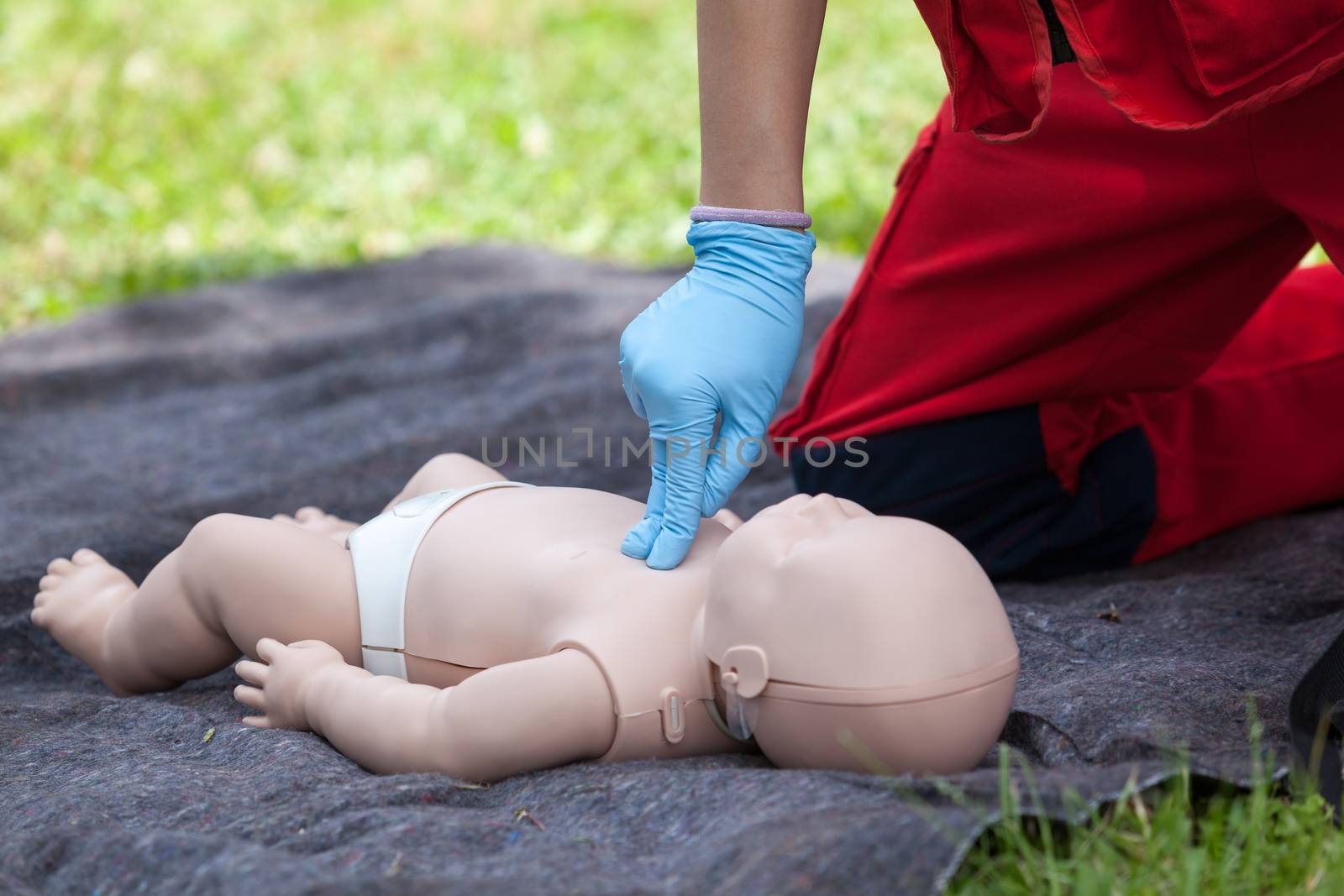 Baby CPR dummy first aid training. Cardiopulmonary resuscitation - CPR. Cardiac massage.