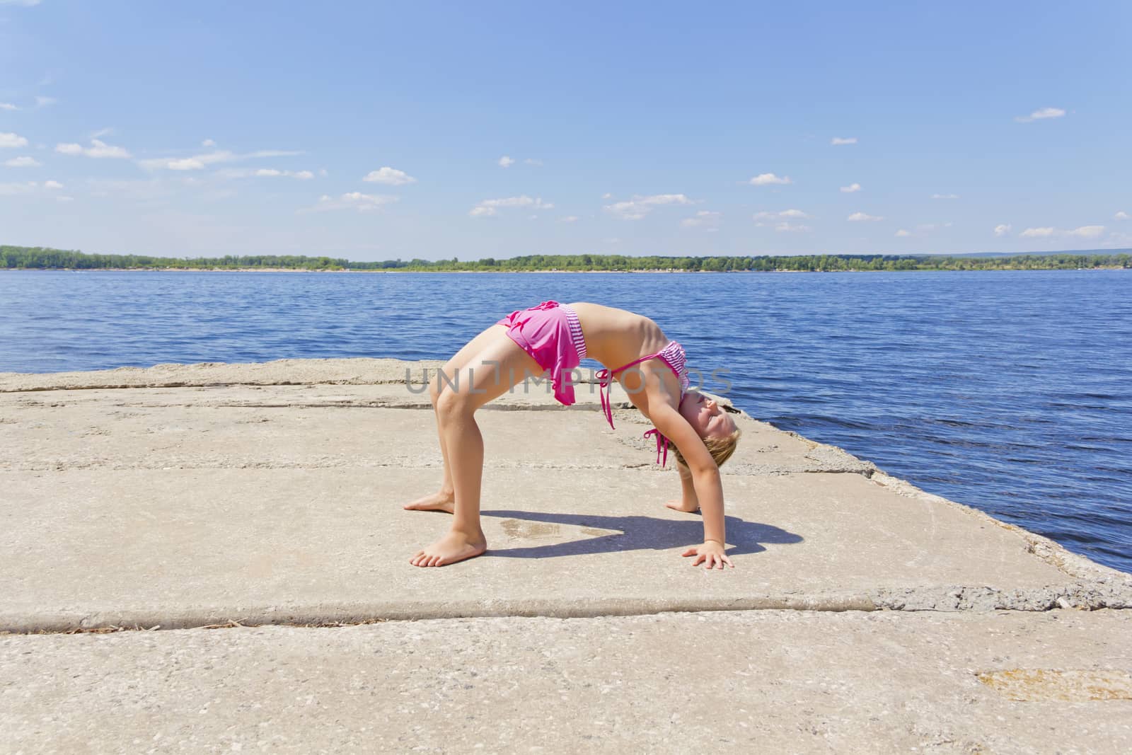 Girl practices yoga  in pose footbridge by Julialine