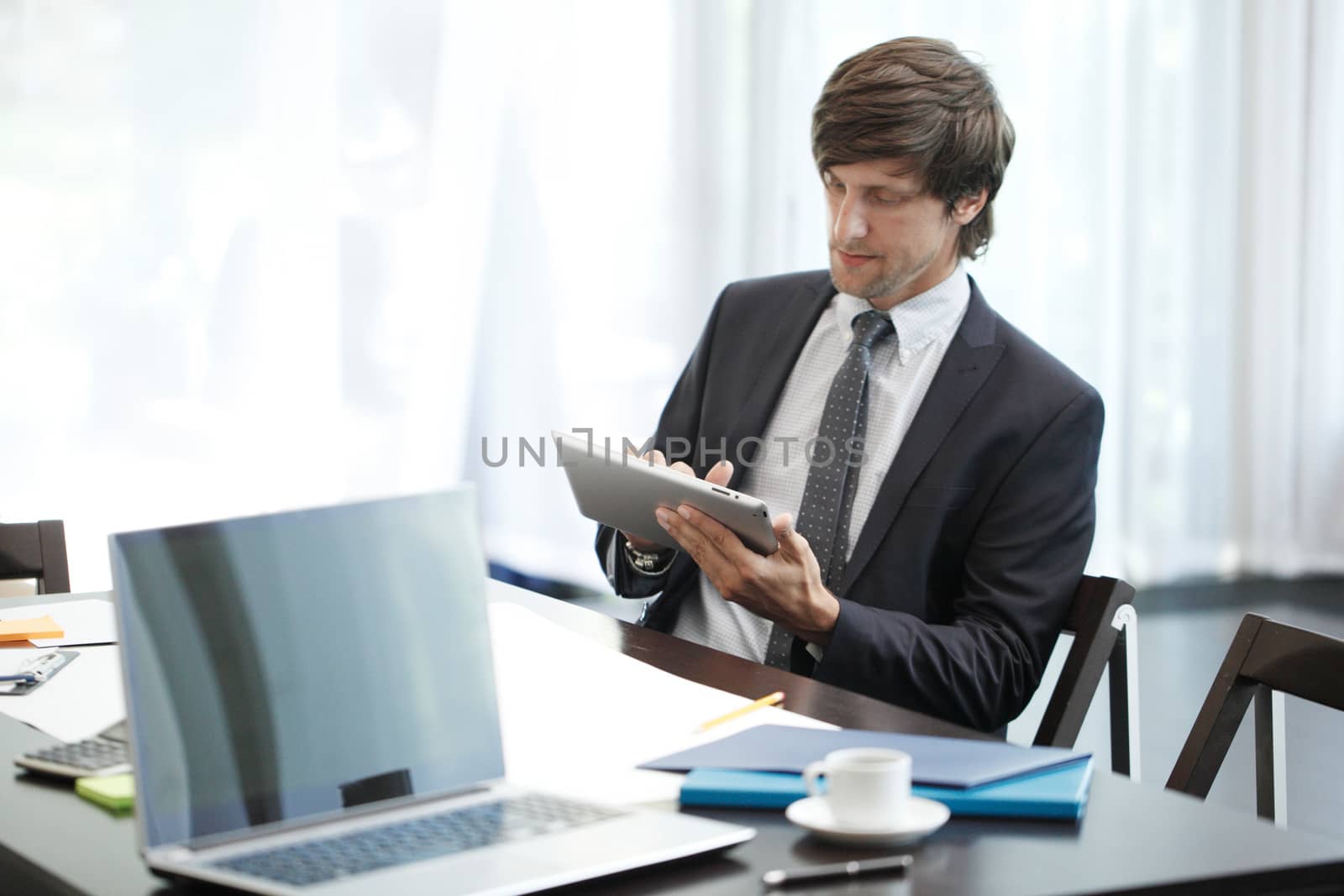 Business man with tablet computer in office