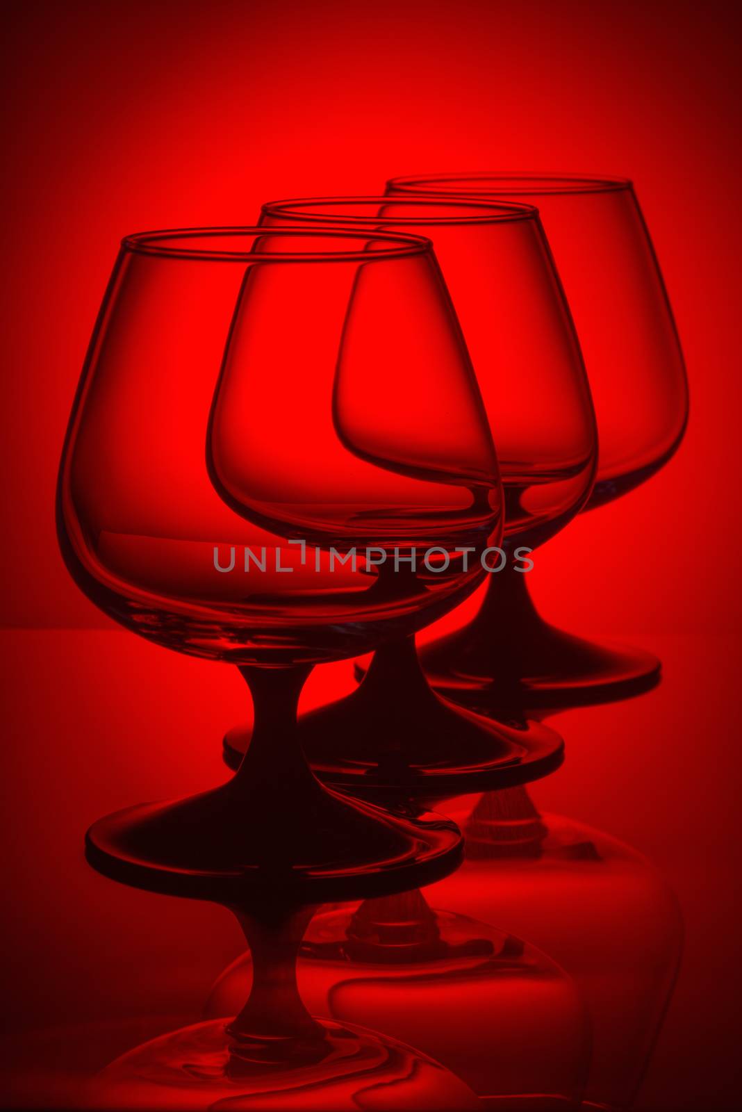 Three glasses in red light by fotooxotnik