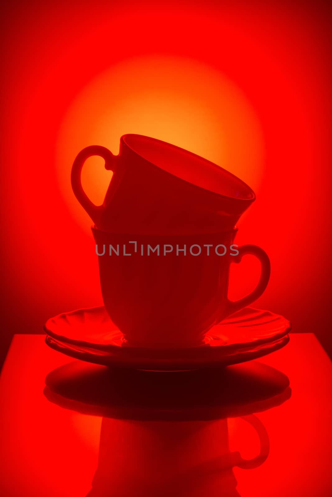 Cups for tea with saucers on a color background
