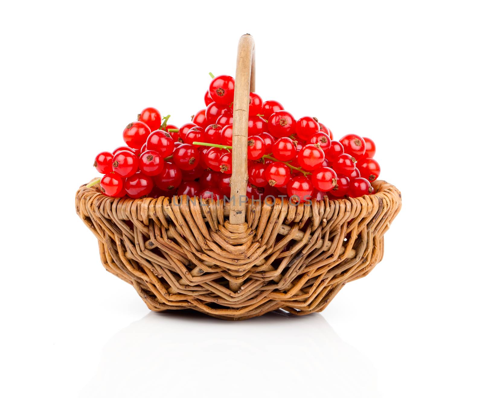 a basket of ripe juicy red currant on white background by motorolka