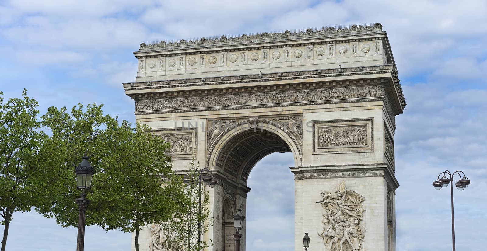 Arc de Triumphe monument popular tourist destination Paris with blue cloudy sky