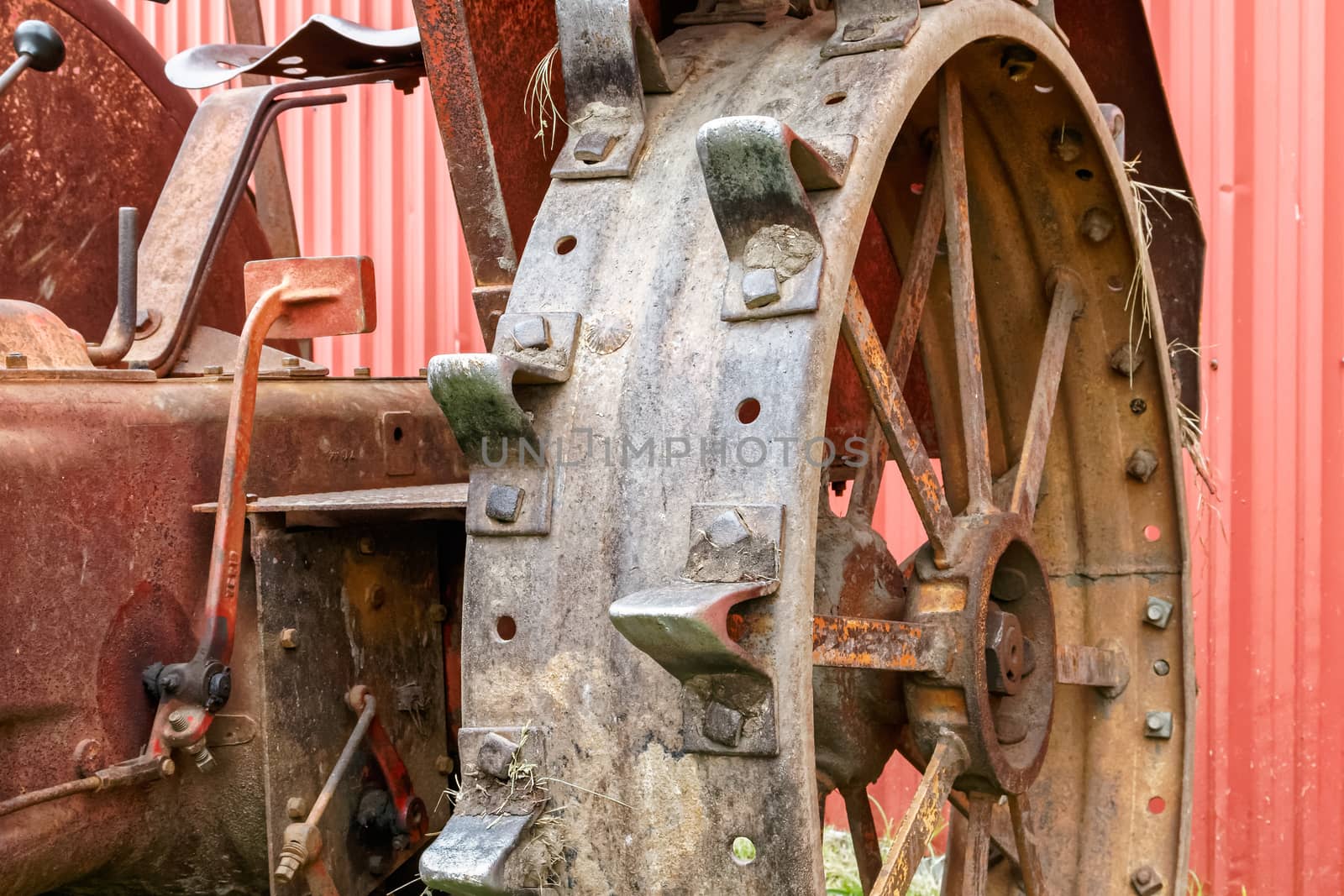 Close-up of the steel wheel of an old tractor