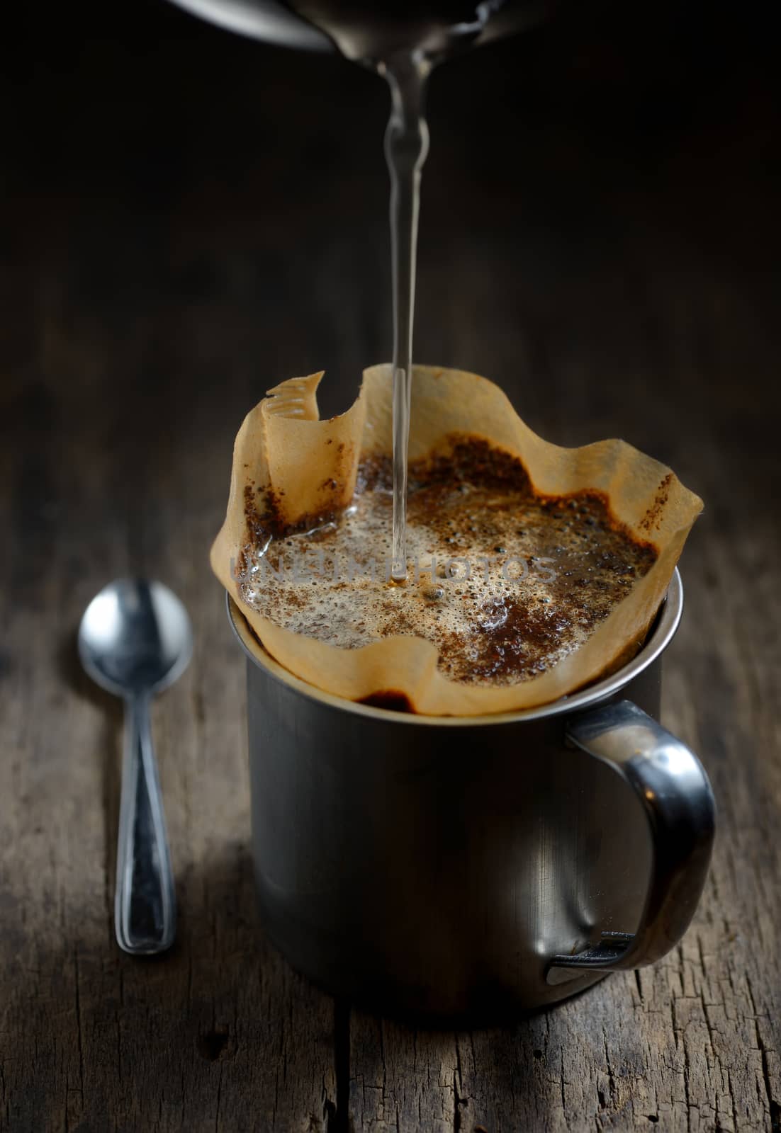 Ground coffee in metal cup and filter holder