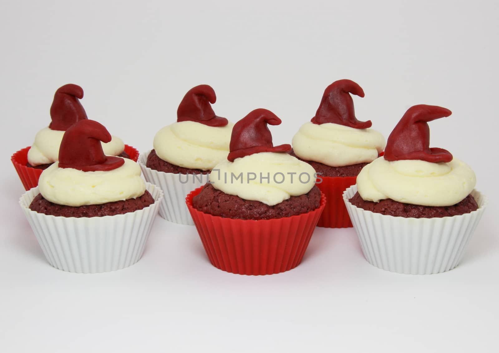 Isolated red velvet cupcakes with cream cheese frosting