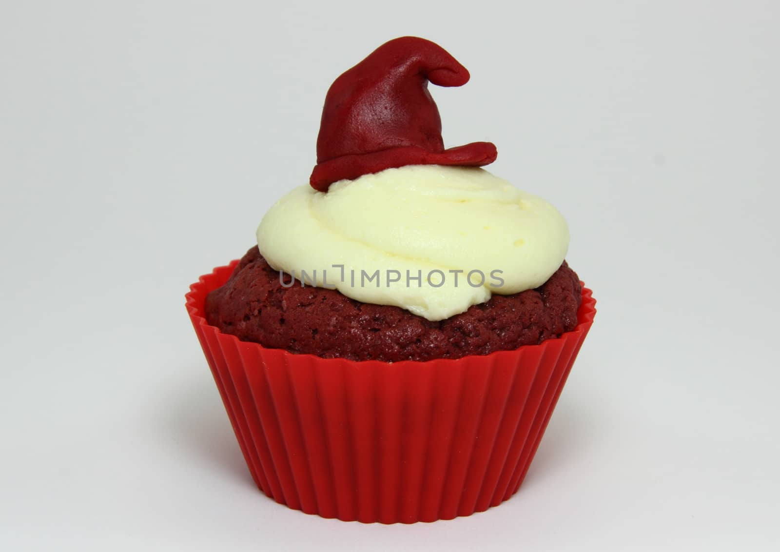 Isolated red velvet cupcake with cream cheese frosting