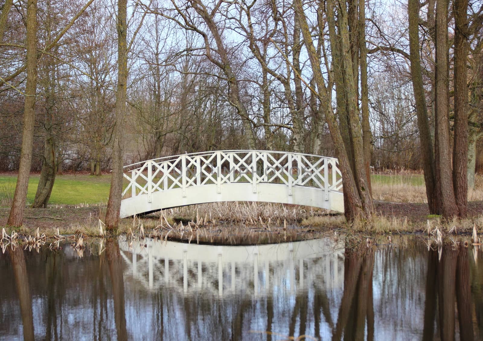 White bridge at small pond in park