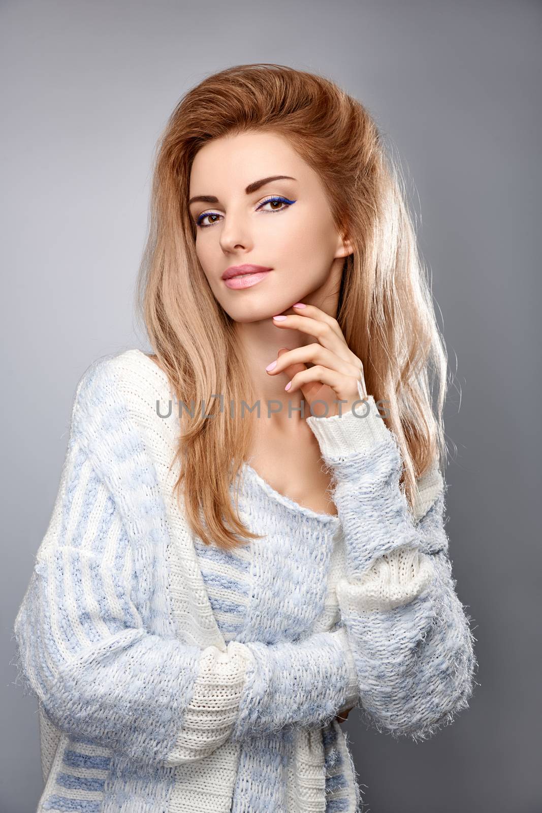 Beauty fashion portrait woman in stylish warm knitted sweater smiling. Sensual attractive pretty blonde sexy model girl, shiny straight hair. Unusual creative provocative. Emotional playful people