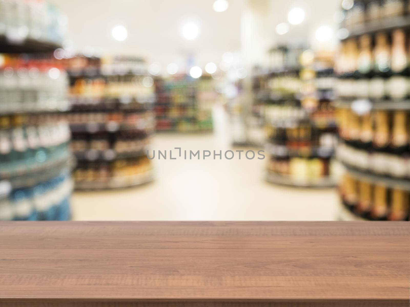 Wooden board empty table in front of blurred background. Perspective dark wood over blur in supermarket - can be used for display or montage your products. Mock up for display of product.