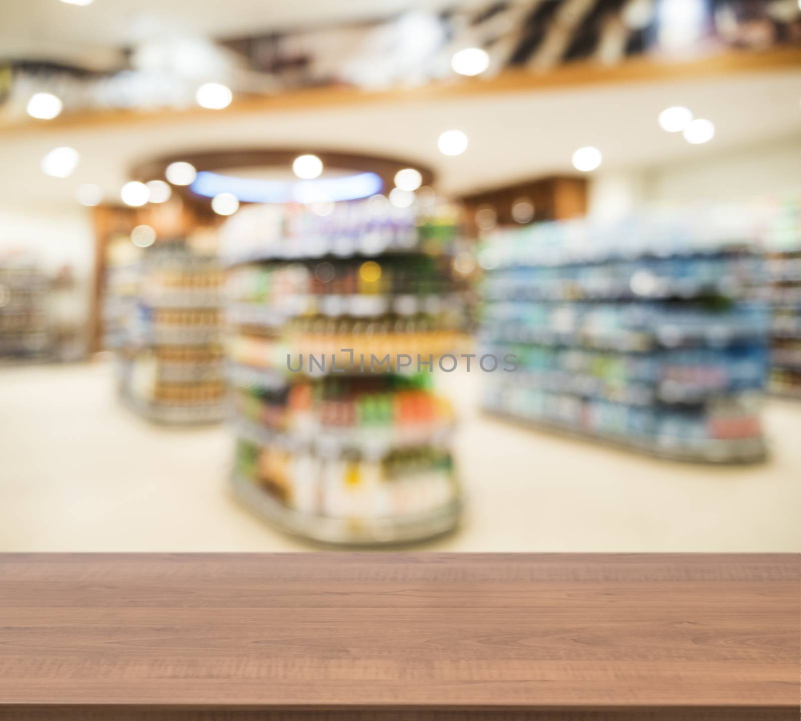 Wooden board empty table in front of blurred background. Perspective dark wood over blur in supermarket - can be used for display or montage your products. Mock up for display of product.