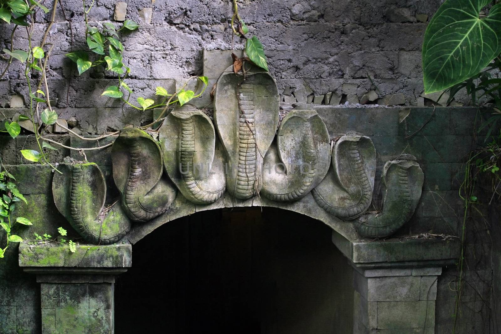 Arch decorated with a bas-relief of cobras. Bali, Indonesia