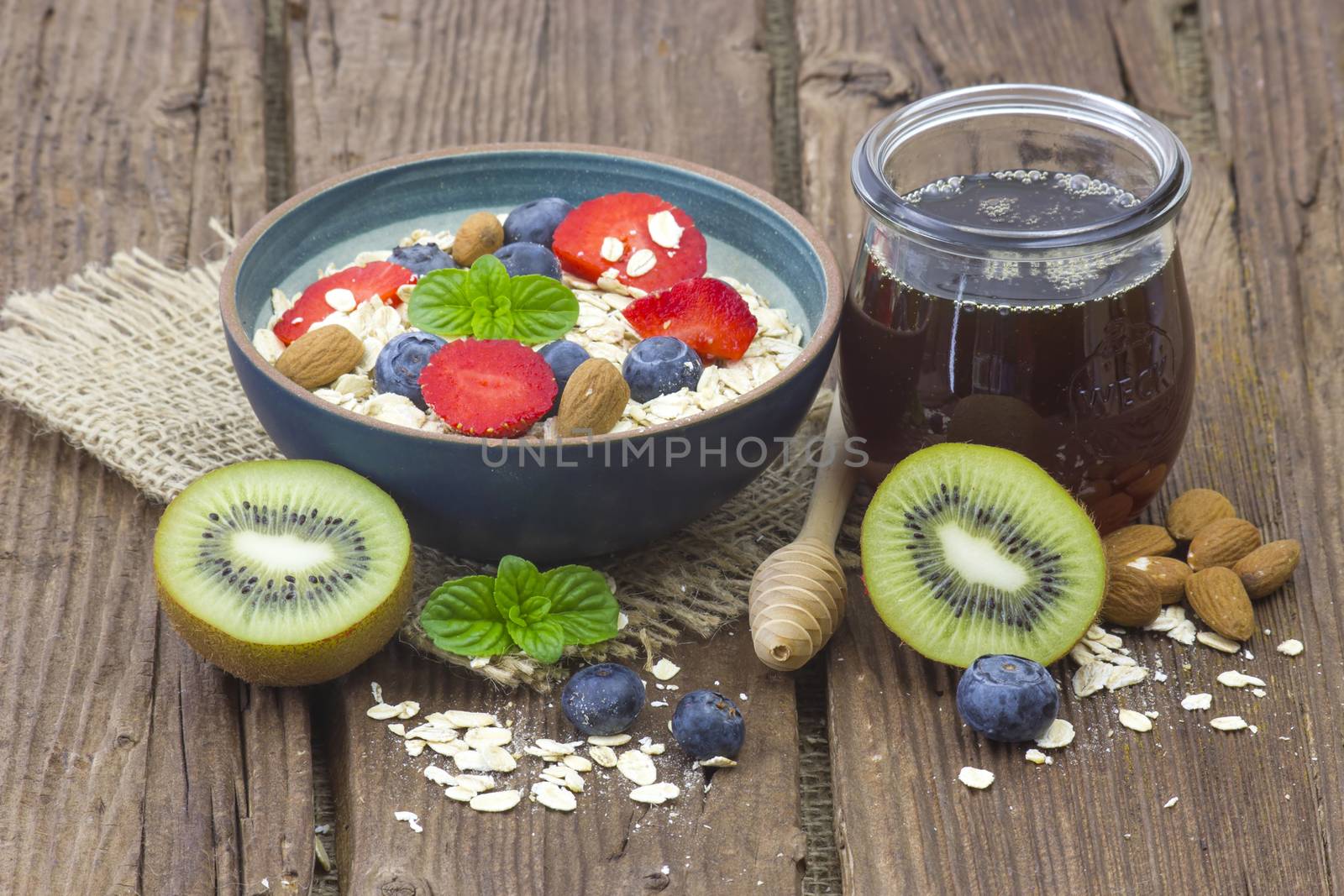 healthy breakfast - muesli with fruit, yogurt and honey by miradrozdowski