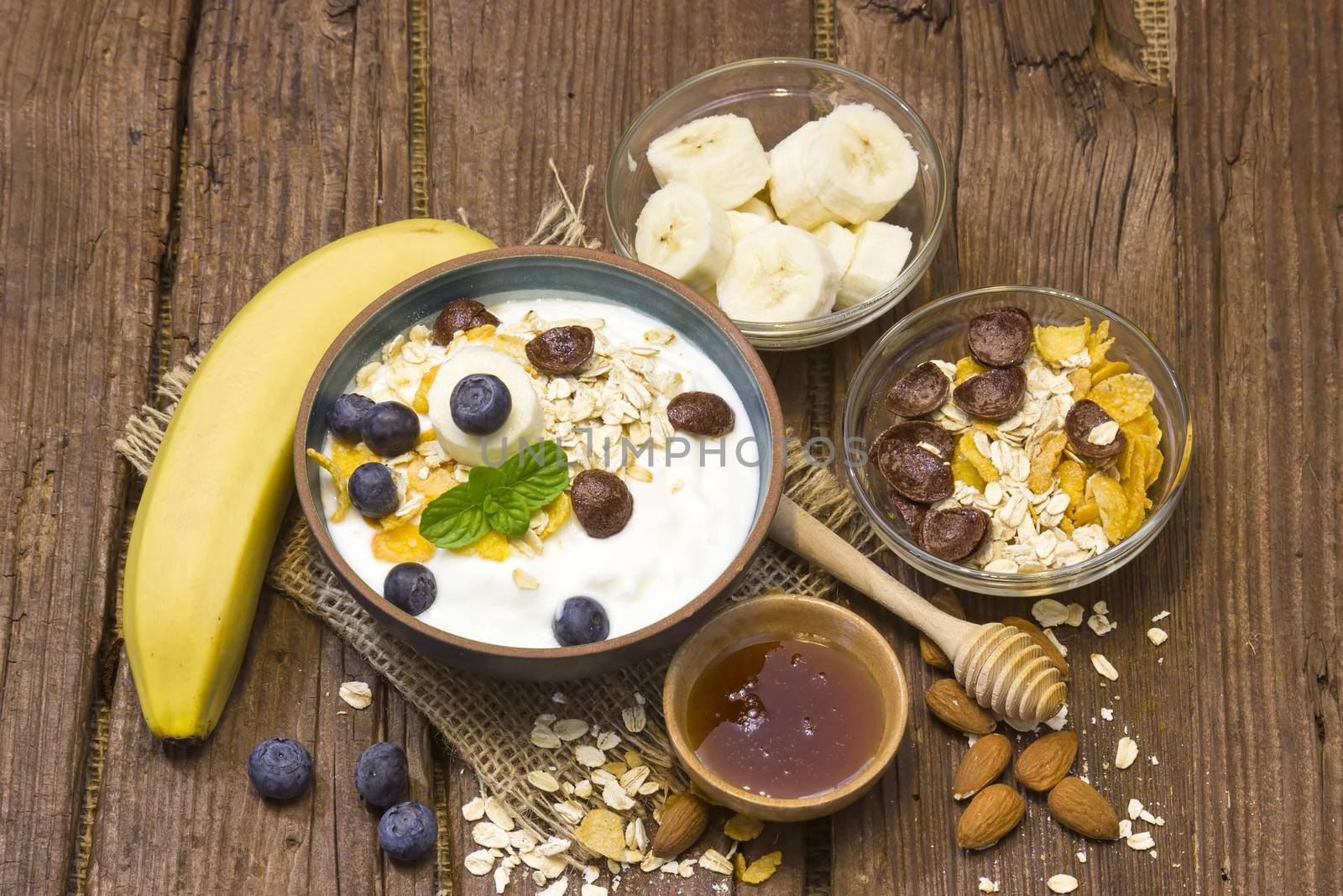 healthy breakfast - muesli with fruit, yogurt and honey