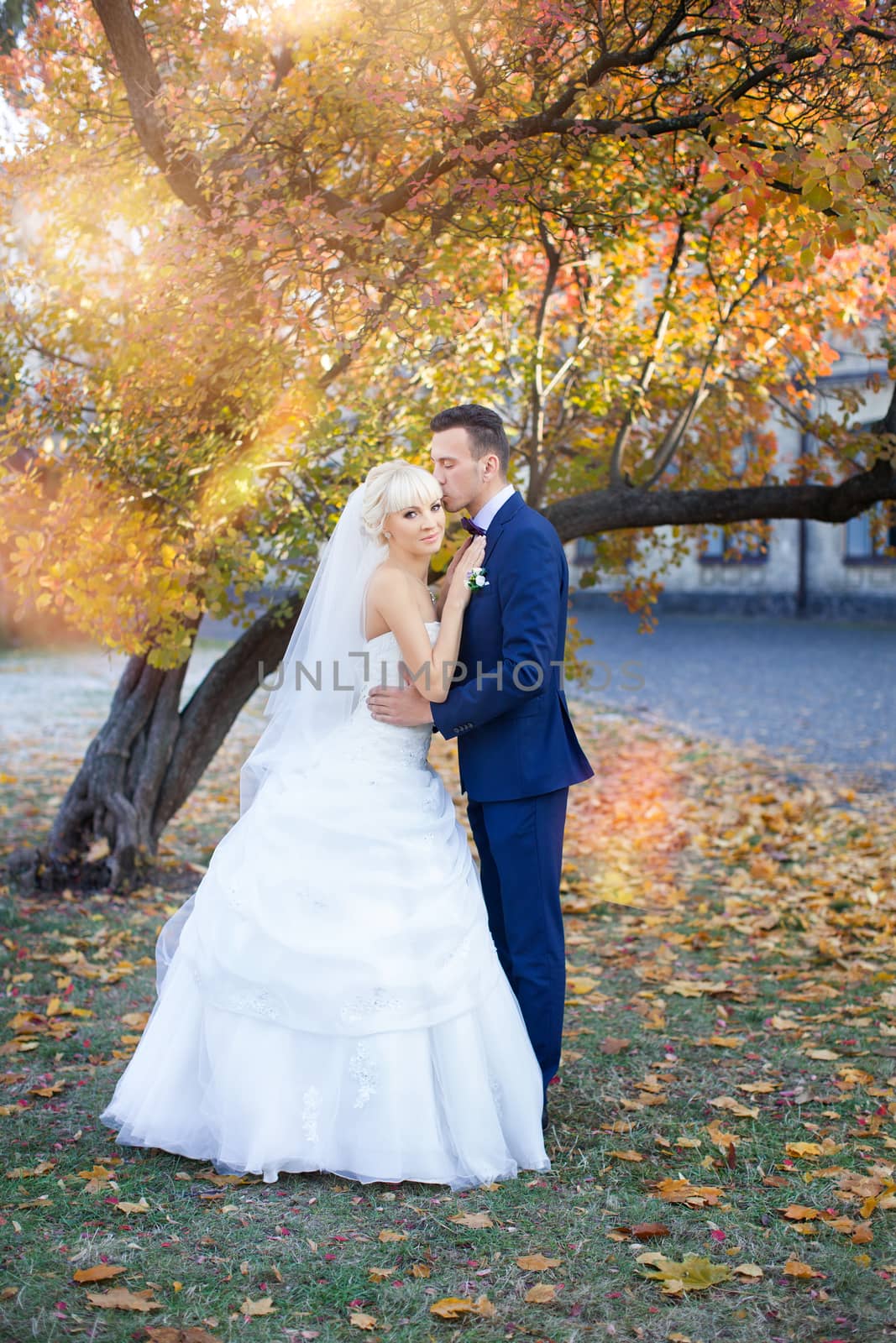 Bride and groom embrace on a walk in the countryside for a walk