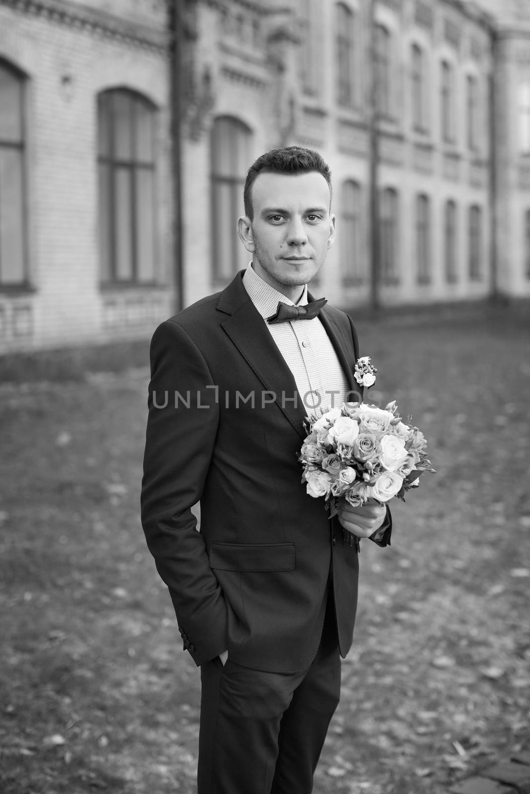 stylish trendy confident happy groom in blue bow  and cute suit