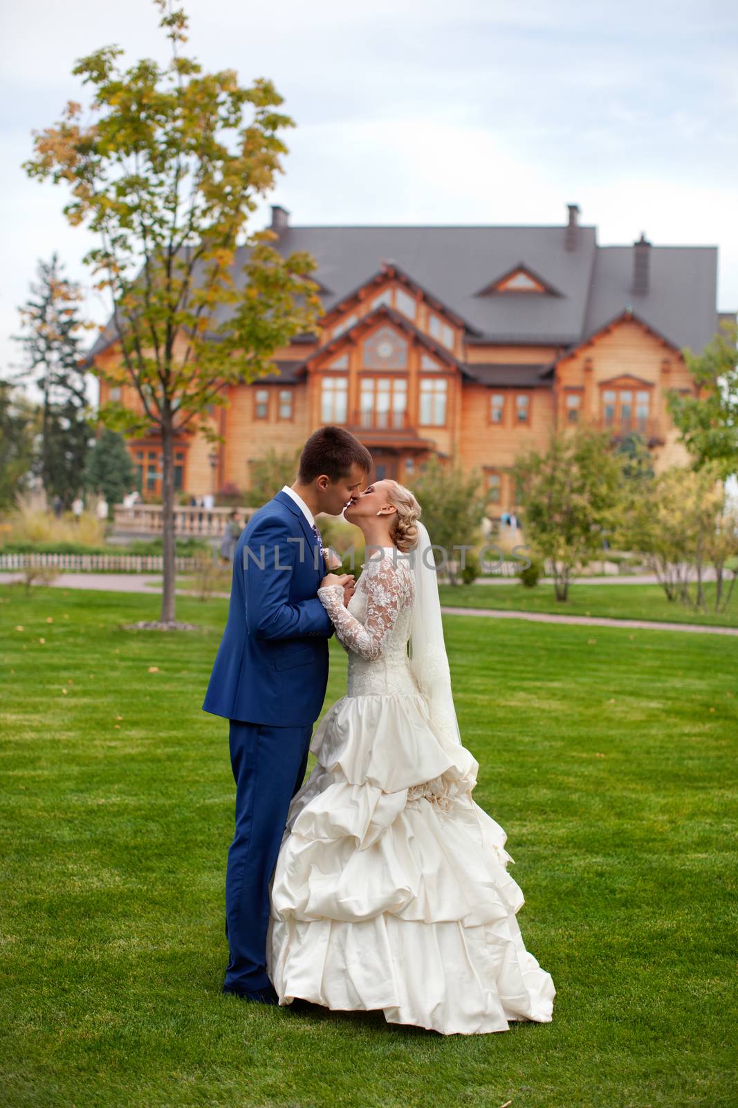 wedding couple hugging and kissing in a private moment of joy