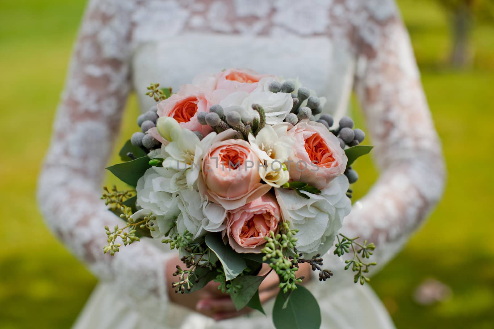 Beautiful wedding bouquet in hands of the bride