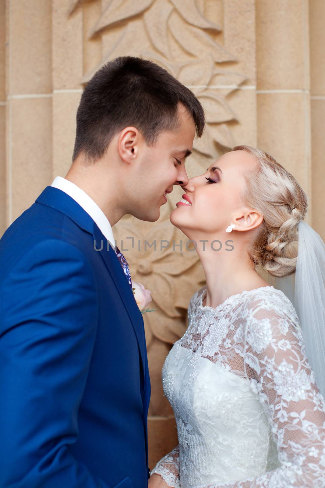 wedding couple hugging and kissing in a private moment of joy