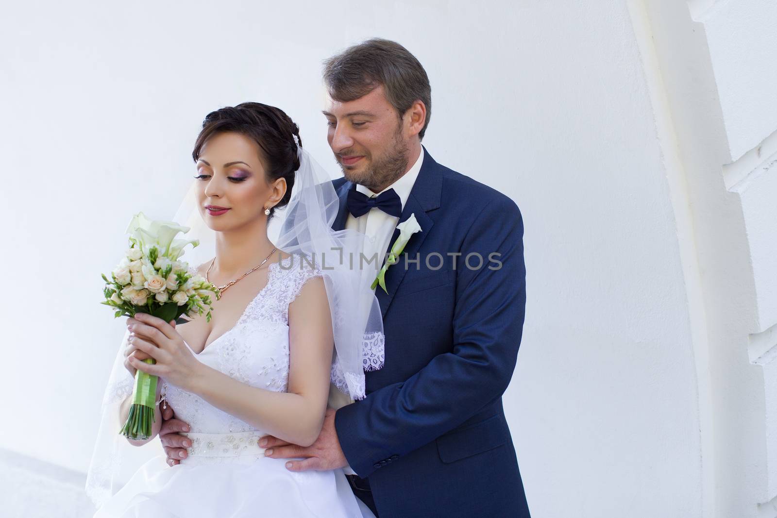 Wedding newlyweds kiss on a sunny day