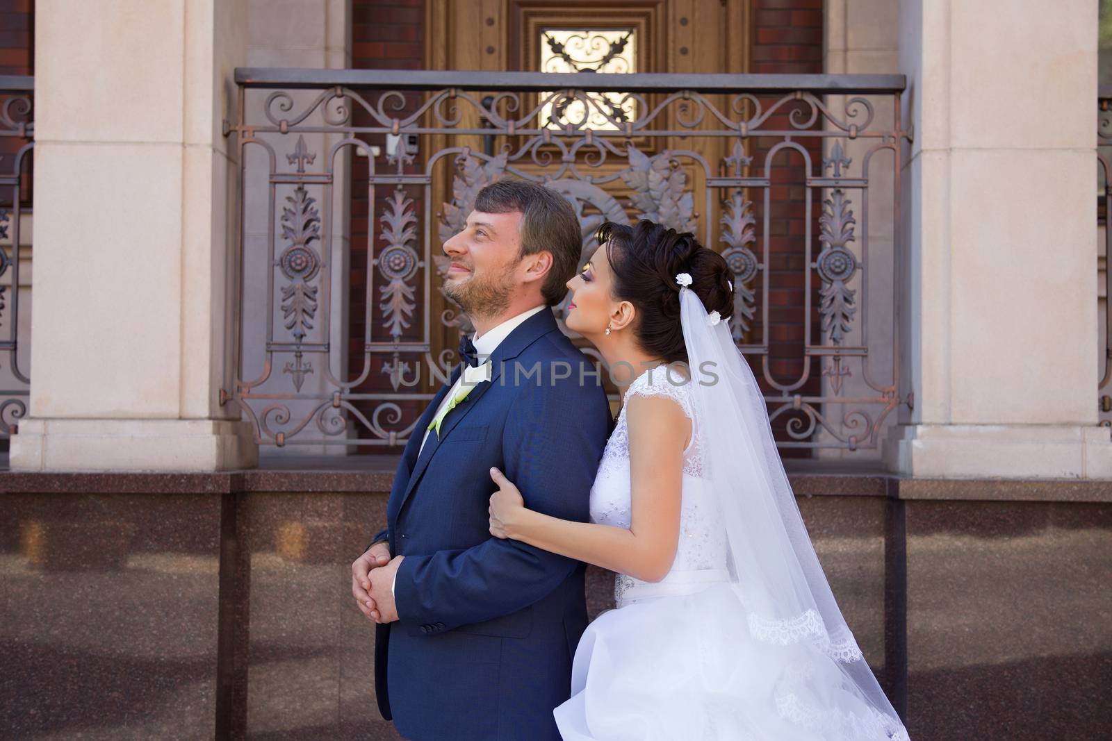 Groom in white shirt kissing bride hand. Very gentle photo