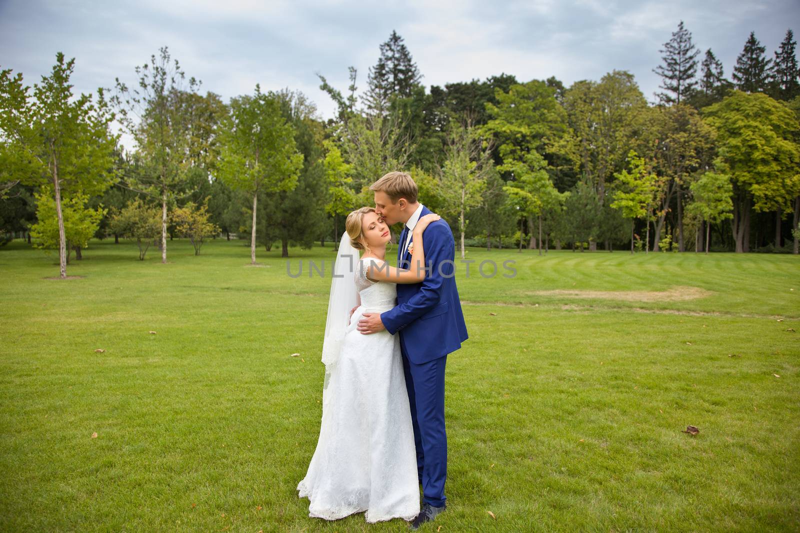 The groom gently hugged the bride